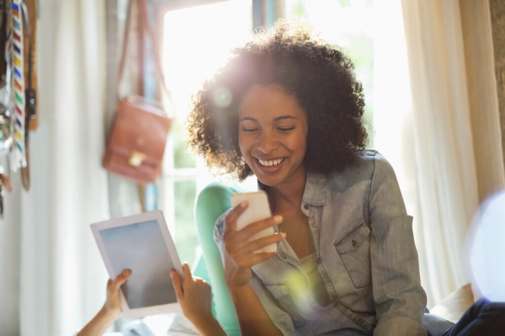 women using tablet computer and cell phone in bedroom 175139715 59a5ebe2aad52b0011674b12