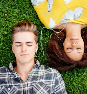 young couple listening to and sharing music 136864002 bc4fae321263458b821a5bbb104e3683