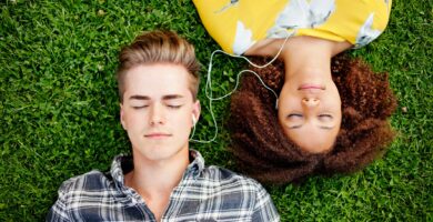 young couple listening to and sharing music 136864002 bc4fae321263458b821a5bbb104e3683