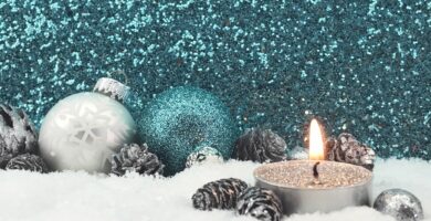 lit candle with christmas decoration on fake snow against glittering wall 758535587 5b480cf346e0fb0037182125