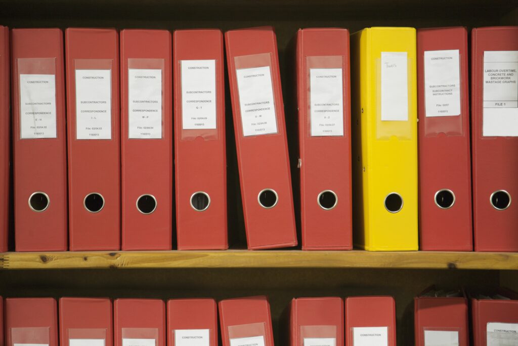 row of red work files with one yellow one 110953663 57ab2a733df78cf45974949c