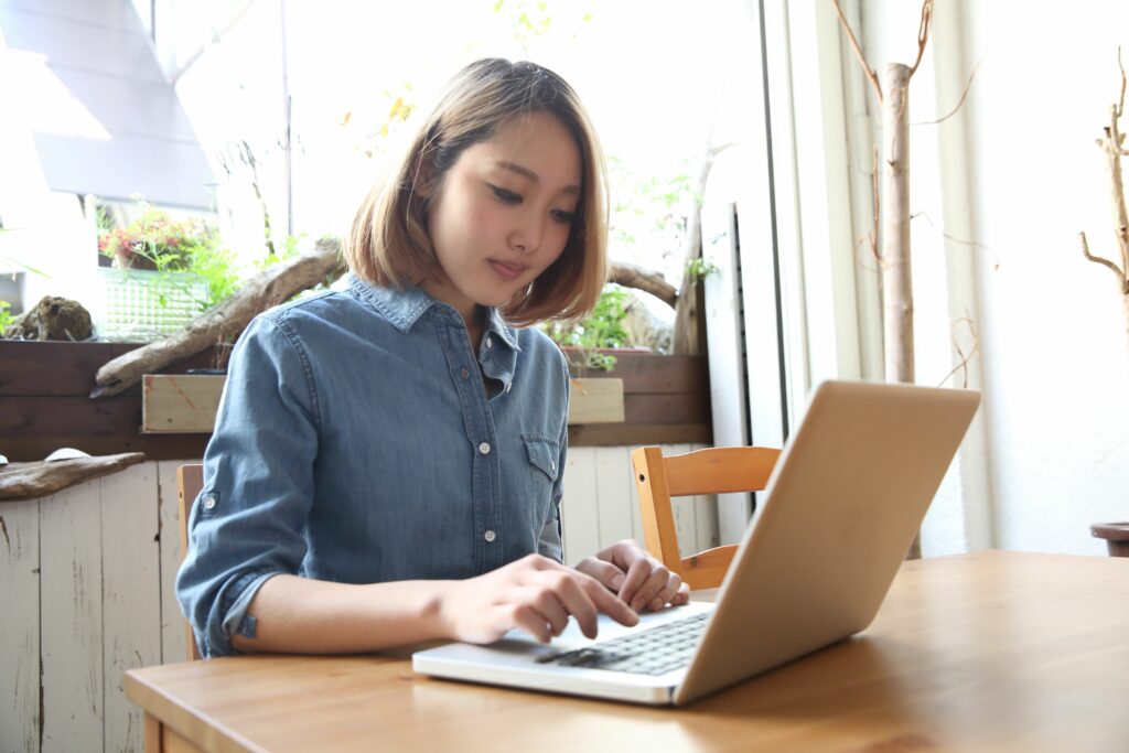 young woman using laptop in cafe 489096003 5a3a8caf89eacc00379c02d8