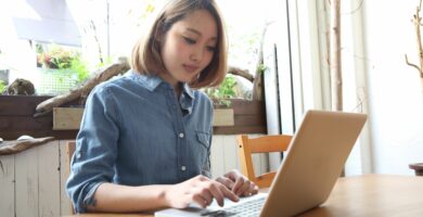 young woman using laptop in cafe 489096003 5a3a8caf89eacc00379c02d8