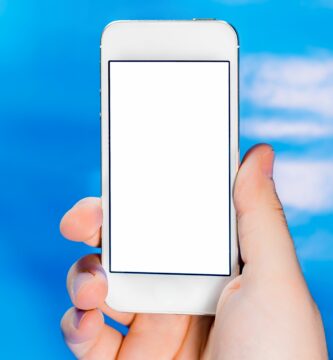 cropped hand holding smart phone against blue background 594187411 57be283d3df78cc16e696ecb