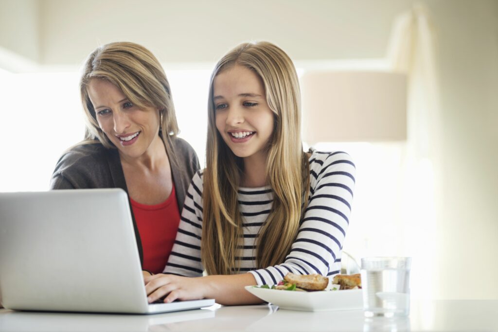 mother and daughter using laptop together at home 179414579 4381f0ceb52048e3950b7de45011902e