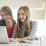mother and daughter using laptop together at home 179414579 4381f0ceb52048e3950b7de45011902e