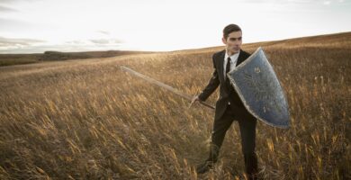 alert businessman with sword and shield outdoors 463029529 5a22e418482c520037a6a079